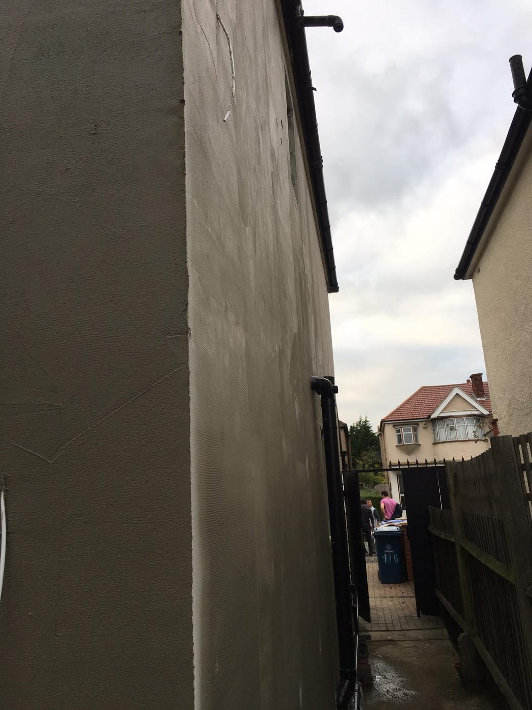 Base-coat render applied over external wall insulation