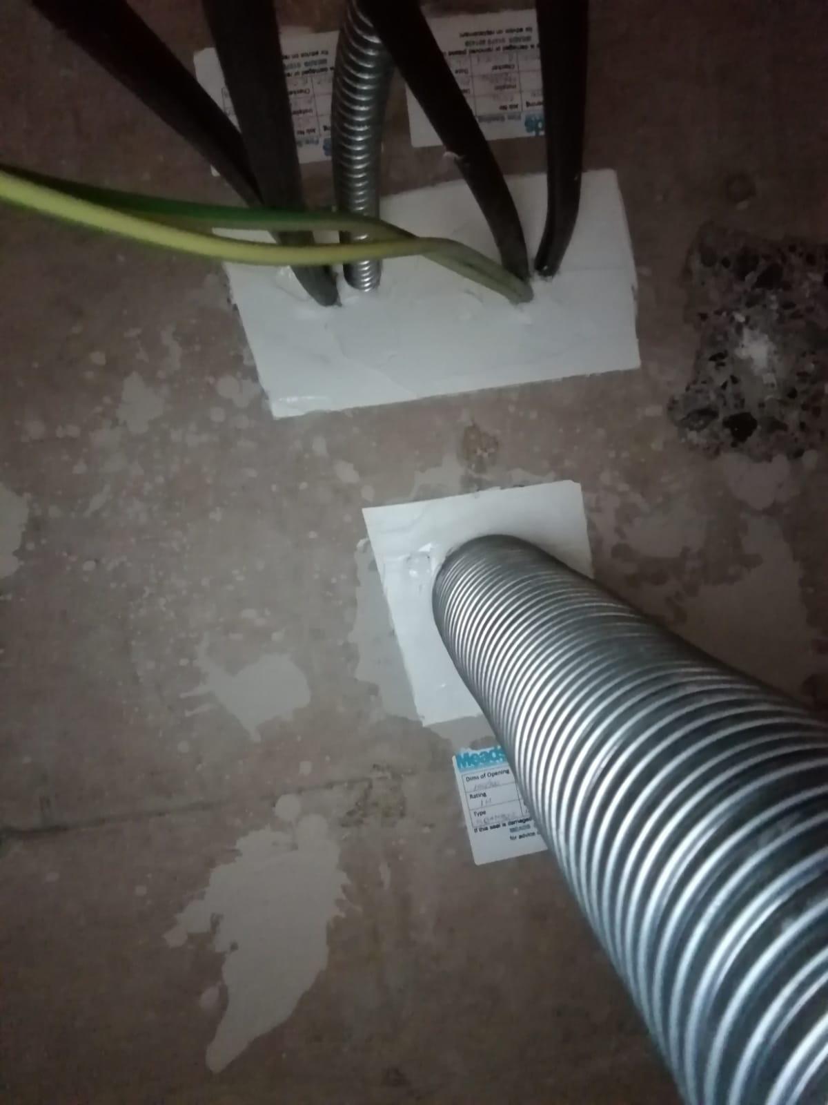 Fire stopped service penetrations through a wall